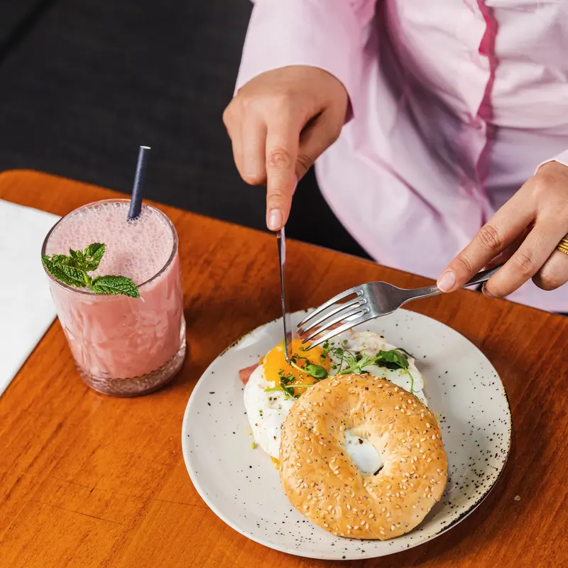 Breakfast Bagel with a pink smoothie