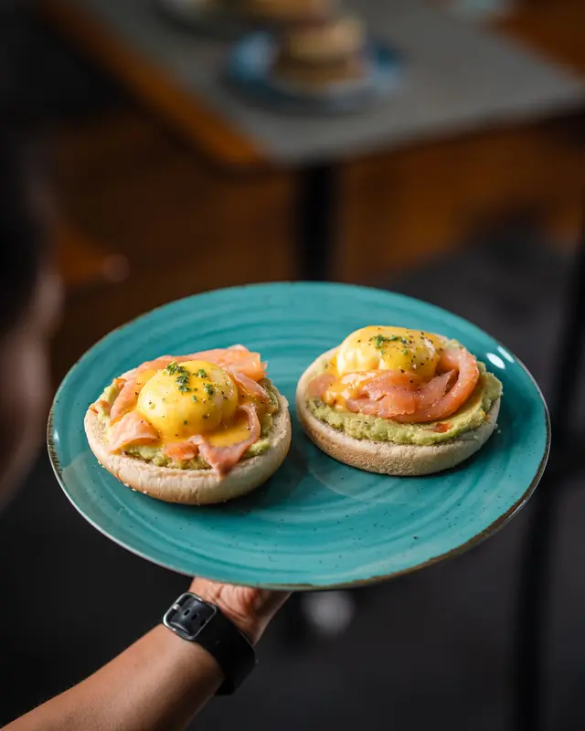 Eggs Benedict carried to the table
