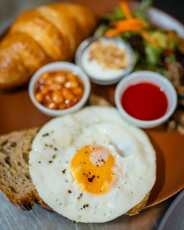 Full Breakfast Plate with fried egg, croissant and baked beans