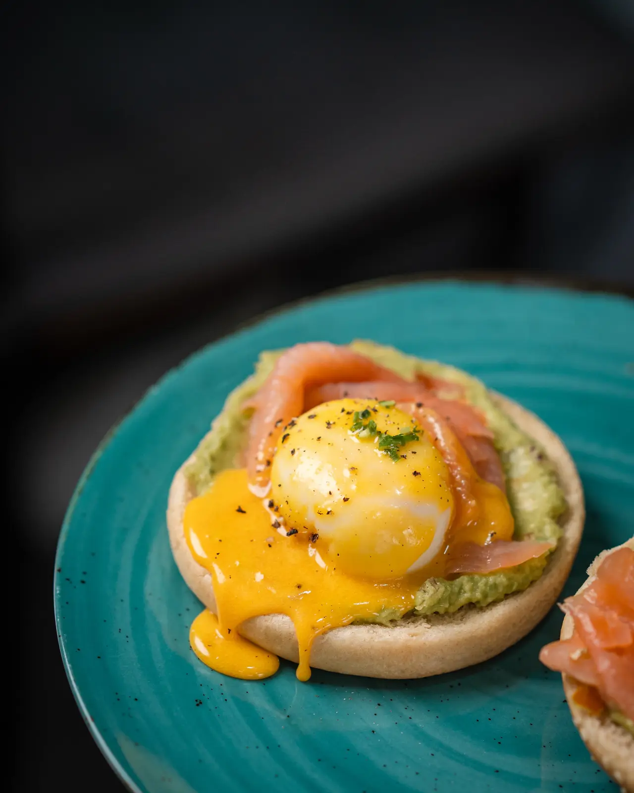 Eggs Benedict with smoked salmon and hollandaise on a teal plate